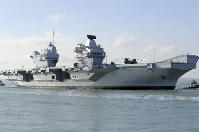 HMS Queen Elizabeth makes her way into Portsmouth Harbour and the Naval Base
Picture by: Malcolm Wells (180227-5957)