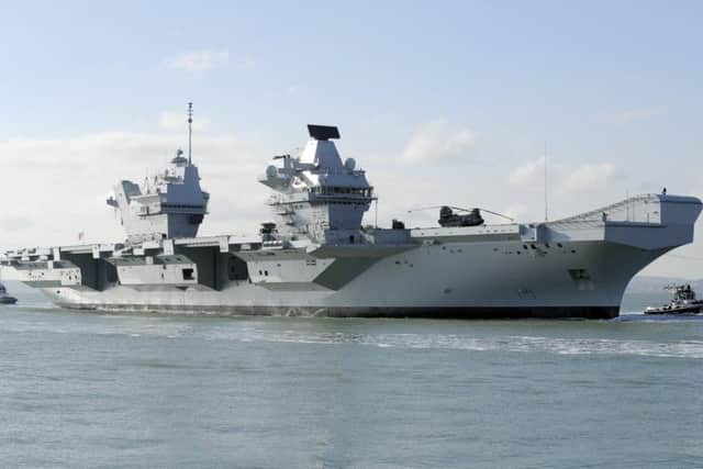 HMS Queen Elizabeth makes her way into Portsmouth Harbour and the Naval Base 

Picture by:  Malcolm Wells (180227-5957)