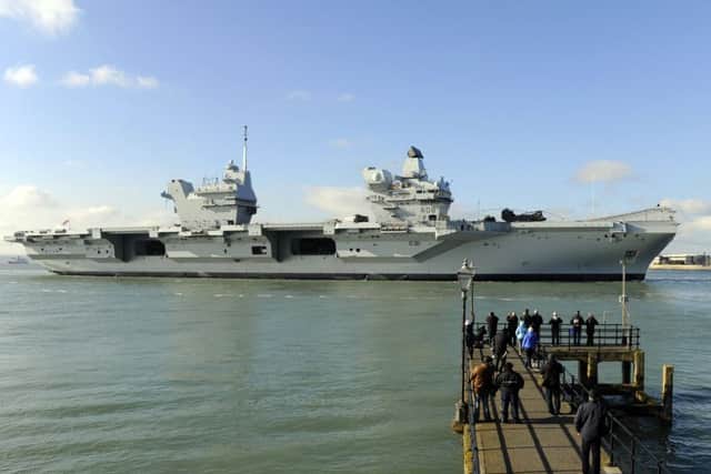 HMS Queen Elizabeth makes her way into Portsmouth Harbour and the Naval Base Picture by:  Malcolm Wells (180227-7944)
