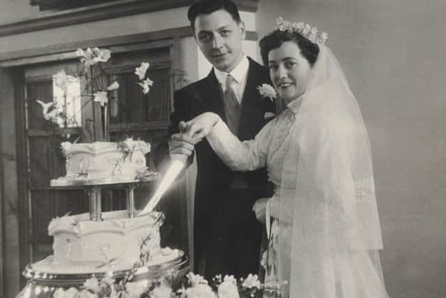 The newlyweds cut the cake after tying the knot at Corpus Christi Church, North End
