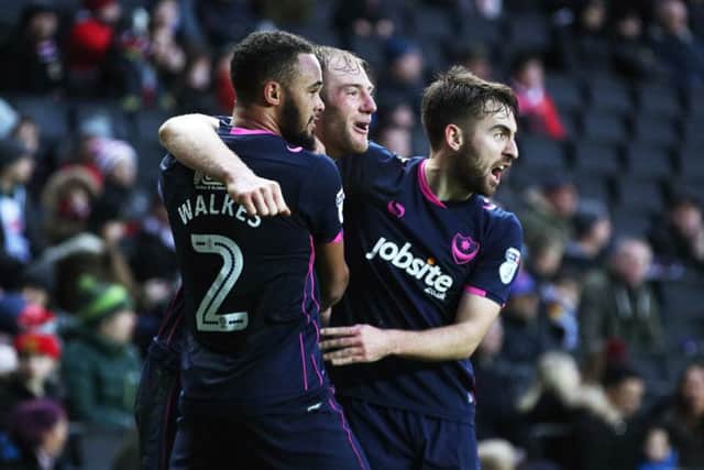 Matt Clarke, centre, celebrates his goal at MK Dons with Anton Walkes, left, and Ben Close. Picture: Joe Pepler