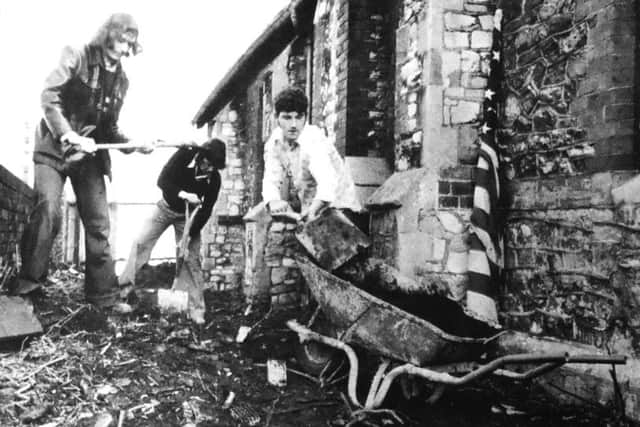 Left to right, Peter Smith, 25, Tony Crowling, 18, and Reg Berry, 17, clearing the ground