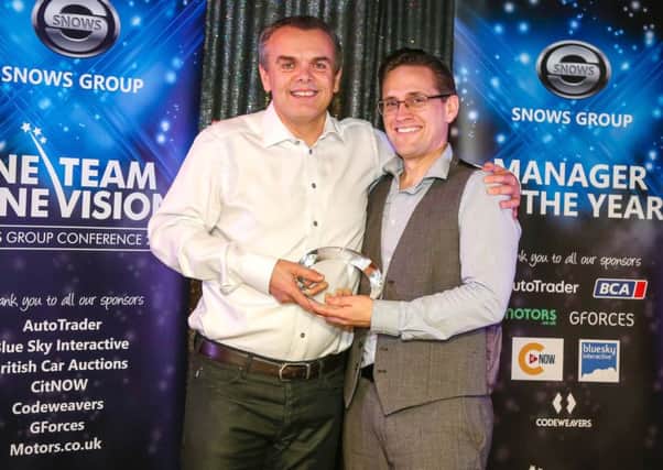 IT manager Stuart Truman, right, receives the inaugural Driving Spirit Manager of the Year award from Stephen Snow, group chairman