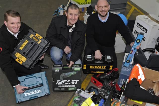 Builder Lee Newman celebrates with staff from Armorgard in Fareham after they organised a tool collection for him following a number of successive thefts of all his equipment from his van. Reuben Mitchell, left, Lee,centre and Graham Fletcher.
Picture Ian Hargreaves (180204-1)