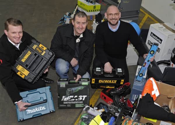 Builder Lee Newman celebrates with staff from Armorgard in Fareham after they organised a tool collection for him following a number of successive thefts of all his equipment from his van. Reuben Mitchell, left, Lee,centre and Graham Fletcher. 
Picture Ian Hargreaves  (180204-1)
