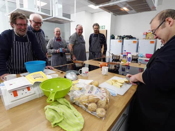 A demonstration from one of the leaders, Trevor, right. Mens' Kitchen at Pompey in The Community, Anson Road, Fratton.         Picture: Chris Moorhouse