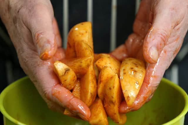 Making spicy potato wedges at Mens' Kitchen at Pompey in The Community, Anson Road, Fratton.         Picture: Chris Moorhouse