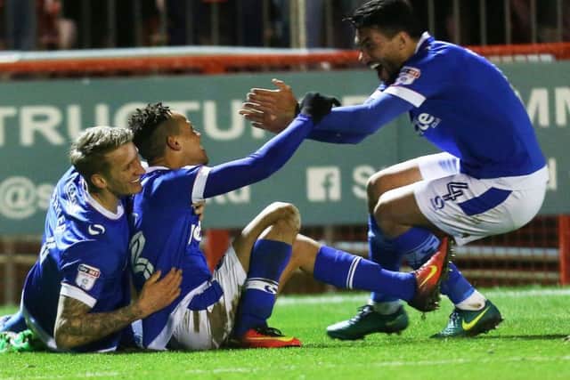 Kyle Bennett, centre, celebrates his winner at Crawley with team-mates Carl Baker and Danny Rose