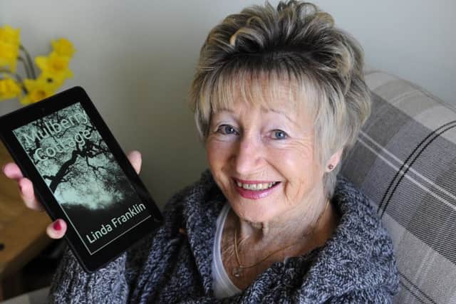 Author Linda Franklin at her Denmead home proudly displaying her first book Mulberry Cottage     Picture: Malcolm Wells (180305-9117)