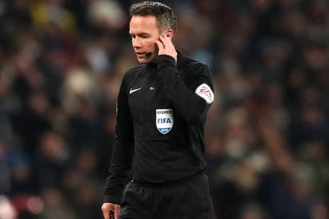Match referee Paul Tierney uses the Video Assistant Referee system to declare Tottenham Hotspur's Erik Lamela's goal disallowed. Picture: Adam Davy/PA