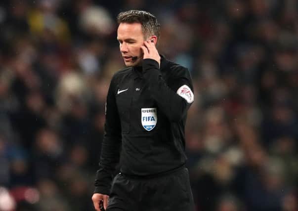 Match referee Paul Tierney uses the Video Assistant Referee system to declare Tottenham Hotspur's Erik Lamela's goal disallowed. Picture: Adam Davy/PA
