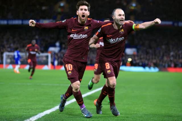 Barcelona's Lionel Messi (left) celebrates scoring his side's first goal of the game with Andres Iniesta during the UEFA Champions League round of sixteen, first leg match at Stamford Bridge. Picture: Nick Potts/PA