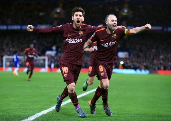 Barcelona's Lionel Messi (left) celebrates scoring his side's first goal of the game with Andres Iniesta during the UEFA Champions League round of sixteen, first leg match at Stamford Bridge. Picture: Nick Potts/PA