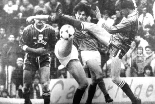 Mick Kennedy puts in a determined challenge against Oldham