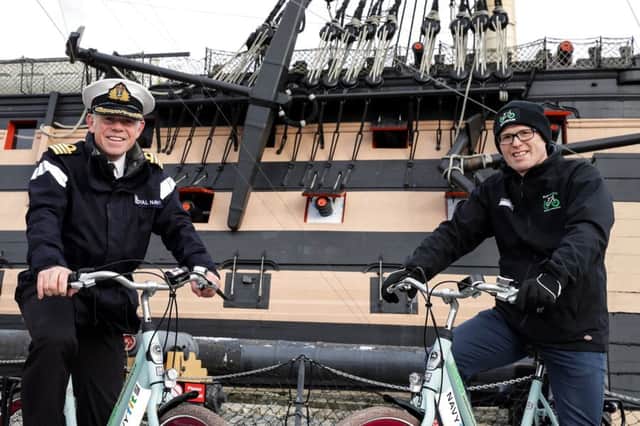Captain Bill Oliphant of HMNB Portsmouth and Charlie Adie, the CEO of Motiv8, operator of the cycle scheme, in front of HMS VICTORY with some of the new NavyFit loan bikes