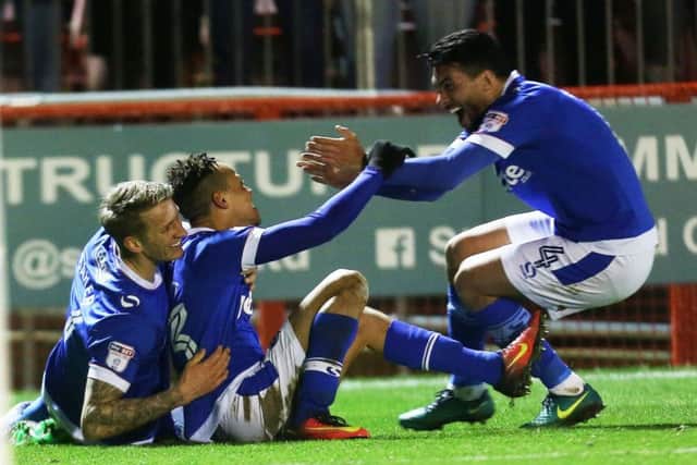 Carl Baker, left, celebrates with goalscorer Kyle Bennett and Danny Rose following his strike in the 2-0 win over Crawley last season