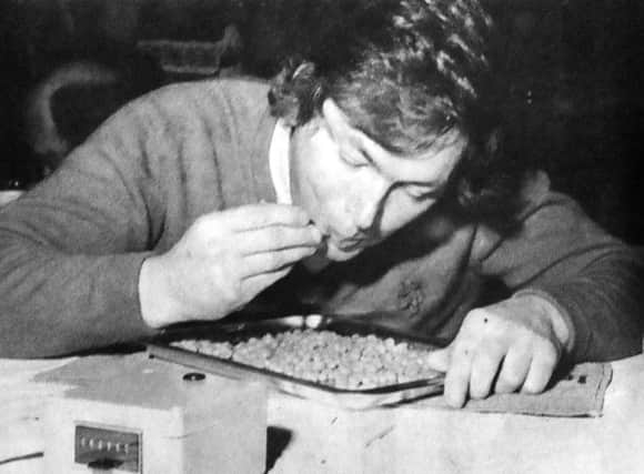 The unusual sight of a bean-eating expert in action as the electronic recorder clicks its way to a world record for John Lawrence