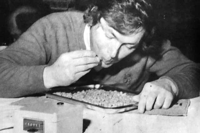 The unusual sight of a bean-eating expert in action as the electronic recorder clicks its way to a world record for John Lawrence