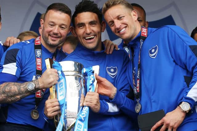 Carl Baker, right, celebrates Pompeys League Two title success with team-mates Noel Hunt and Gary Roberts