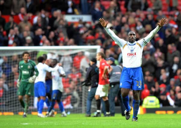 Sol Campbell hails the Pompey faithful after the full-time whistle at Old Trafford. Picture: Steve Reid (080950-158)