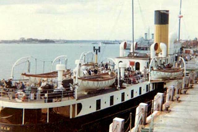 The paddle steamer Whippingham showing her lifeboats seen alongside Portsmouth Harbour landing stage we see the Whippinghams lifeboats.