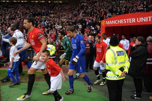 The teams walk out on to the pitch at Old Trafford. Picture: Steve Reid