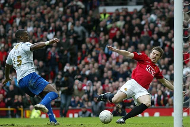Sylvain Distin foils Michael Carrick. Picture: Steve Reid