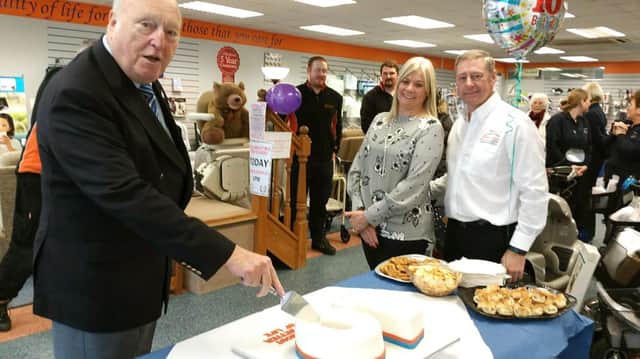 Alderman Derek Kimber (left) cutting the cake with Directors Debbie and Michael Watts (right) and Solent Mobility Team and shoppers
