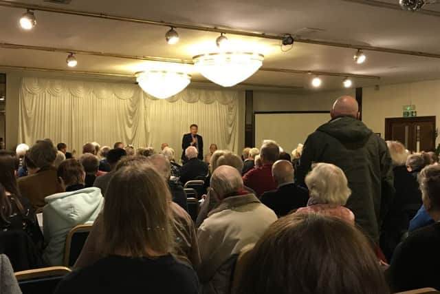A resident poses a question to Portsmouth City Council chief executive David Williams