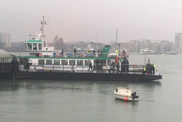 The man, pictured far right, was pulled out of the habour and is being tended to on a pontoon. Image: Shaun Daniels