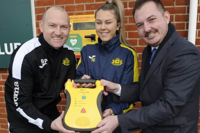 A new defibrilator has been installed at Moneyfields football Club in Copnor.From left:  football coach Brandon Parker, player Grace Laidlaw and community campaigner, Terry Norton     Picture Ian Hargreaves  (180220-1)