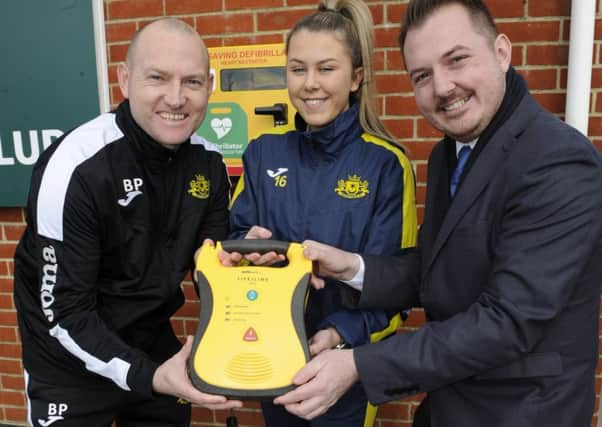 A new defibrilator has been installed at Moneyfields football Club in Copnor.From left:  football coach Brandon Parker, player Grace Laidlaw and community campaigner, Terry Norton     
Picture Ian Hargreaves  (180220-1)
