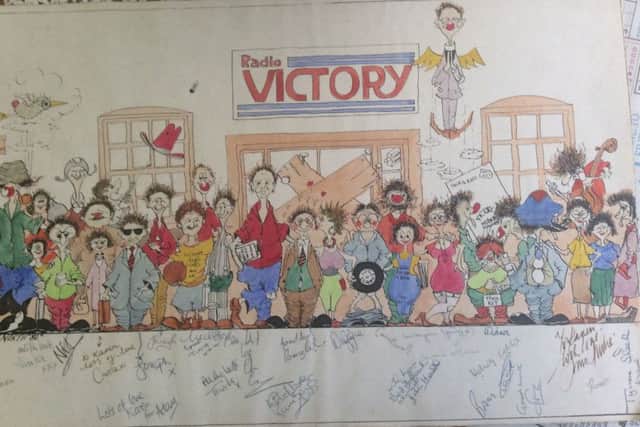 Mike Norths cartoon of Radio Victory staff outside the nailed-up front door to the station.