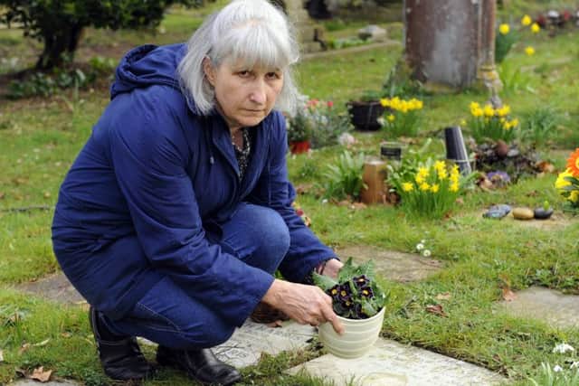 Jackie Quinn tends her husband's memorial stone Picture: Malcolm Wells