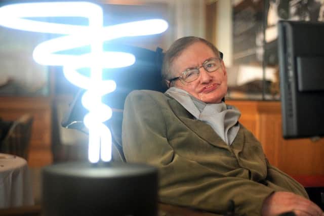 Professor Stephen Hawking, who has died aged 76, posing beside a lamp titled 'black hole light' by inventor Mark Champkins, presented to him during his visit to the Science Museum in London.  Anthony Devlin/PA