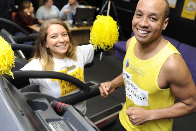 Former Great British Bake Off contestant Enwezor Nzegwu takes part in a 24-hour treadmill relay at Portsmouth University Gym to raise money for cystic fibrosis. Fellow participant Dannii Hutchins gives support. Picture Ian Hargreaves  (180224-1)