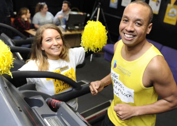 Former Great British Bake Off contestant Enwezor Nzegwu takes part in a 24-hour treadmill relay at Portsmouth University Gym to raise money for cystic fibrosis. Fellow participant Dannii Hutchins gives support. 
Picture Ian Hargreaves  (180224-1)