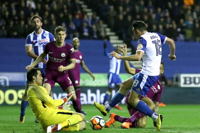 Gary Roberts goes through on goal for Wigan in their FA Cup win against Manchester City. Picture: PA Images