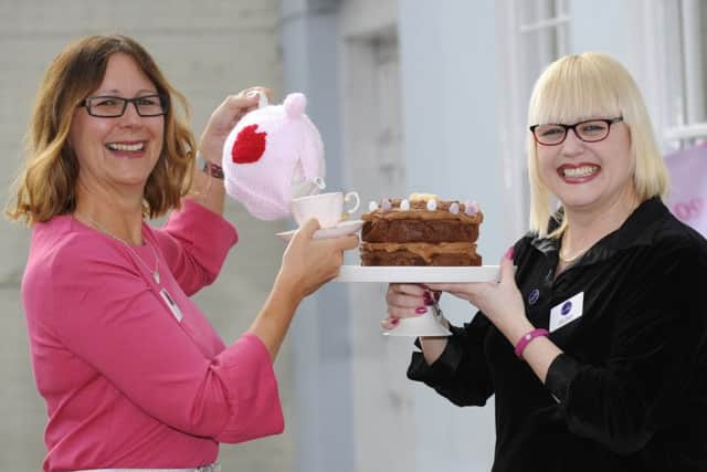Marian Parfitt, Breast Cancer Haven Macmillan manager, pours a cuppa to go with a slice of cake for Sally Hillyear, fundraising manager at The Haven in Titchfield      Picture: Malcolm Wells (180315-8302)