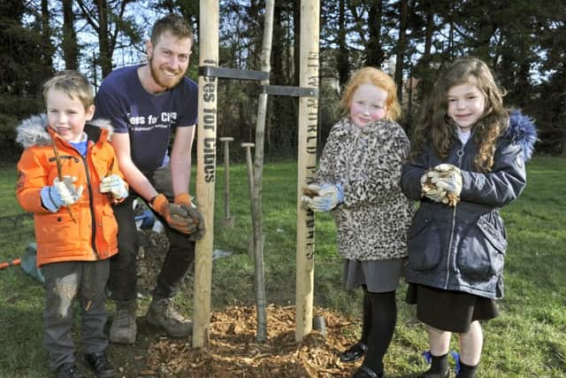 Children from Penhale Infants School have taken part in a tree planting initiative at Kingston Park with a team from Trees For Cities. From left, Lucas Chapman, Rory Harding, Ruby Elmes and Florence Evans. Picture Ian Hargreaves  (180217-1)