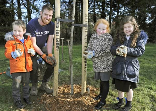 Children from Penhale Infants School have taken part in a tree planting initiative at Kingston Park with a team from Trees For Cities. From left, Lucas Chapman, Rory Harding, Ruby Elmes and Florence Evans. 
Picture Ian Hargreaves  (180217-1)