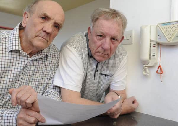 Residents at Spring Court in Lee-on-the-Solent are angry after being told by their management company that they are each going to have to pay Â£800 to have new individual pull cords installed. Residents Michael Chapman and David Heather.
Picture Ian Hargreaves  (180215-1)