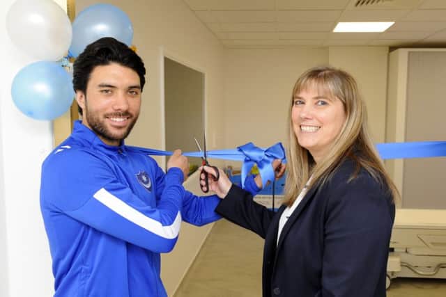 Pompey midfielder Danny Rose cuts the ribbon to open the new scanner with Nicky Wragg CT/MR Superintendent at Queen Alexandra Hospital, Portsmouth. Picture: Malcolm Wells (180319-1020)