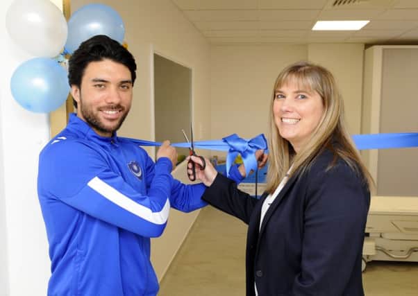 Pompey midfielder Danny Rose cuts the ribbon to open the new scanner with Nicky Wragg CT/MR Superintendent at Queen Alexandra Hospital, Portsmouth. Picture: Malcolm Wells (180319-1020)