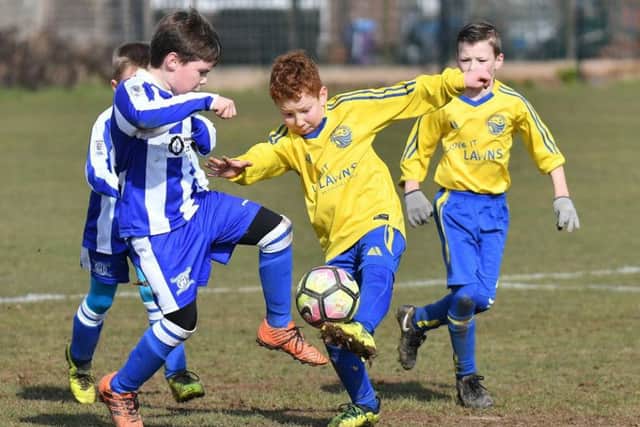 Meon Milton Saunders, yellow, against Hayling St Andrew. Picture: Neil Marshall (171742-134)