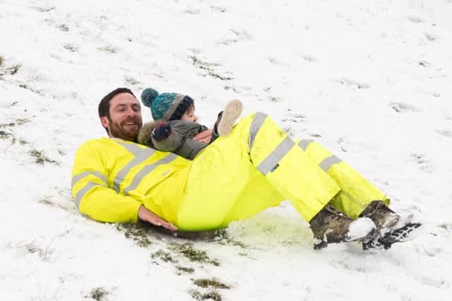 Jake and Maverick Gofton enjoy the snow. in Southsea. Credit: Keith Woodland