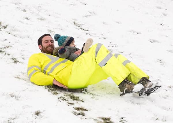 Jake and Maverick Gofton enjoy the snow. in Southsea. Credit: Keith Woodland