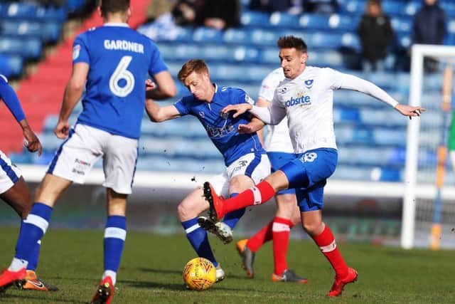Brandon Haunstrup battles Eoin Doyle for the ball in Pompey's 2-0 win at Oldham. Picture: Joe Pepler