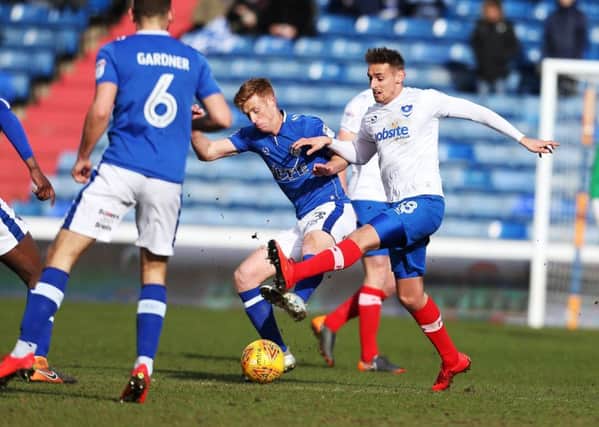 Brandon Haunstrup battles Eoin Doyle for the ball in Pompey's 2-0 win at Oldham. Picture: Joe Pepler