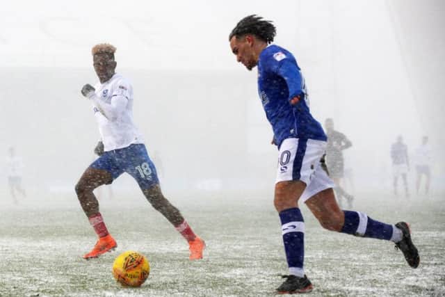 Oldham's Kean Bryan delivers a cross against Pompey. Picture: Joe Pepler